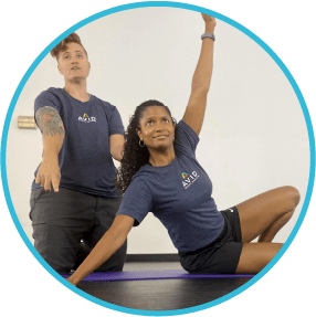 Athletic trainer helping woman do stretch