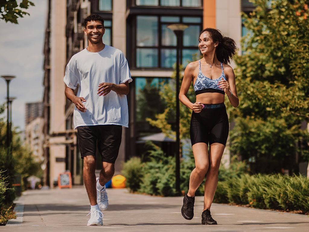 Two young people running together