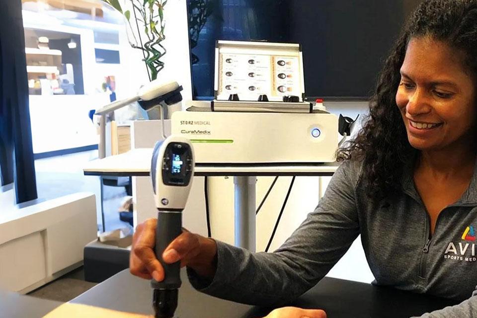 Dr Veronica Jow using shockwave machine