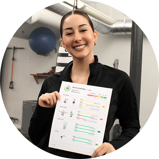 smiling person in a gym holds a health report card with a score of 75