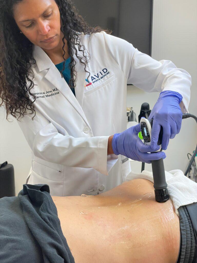 Dr. Veronica Jow performing Shockwave therapy treatment at Avid Sports Medicine